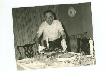 Jack Fox serving dinner, circa 1950s, Jewish Neighborhood Voices collection in the JHC archive.