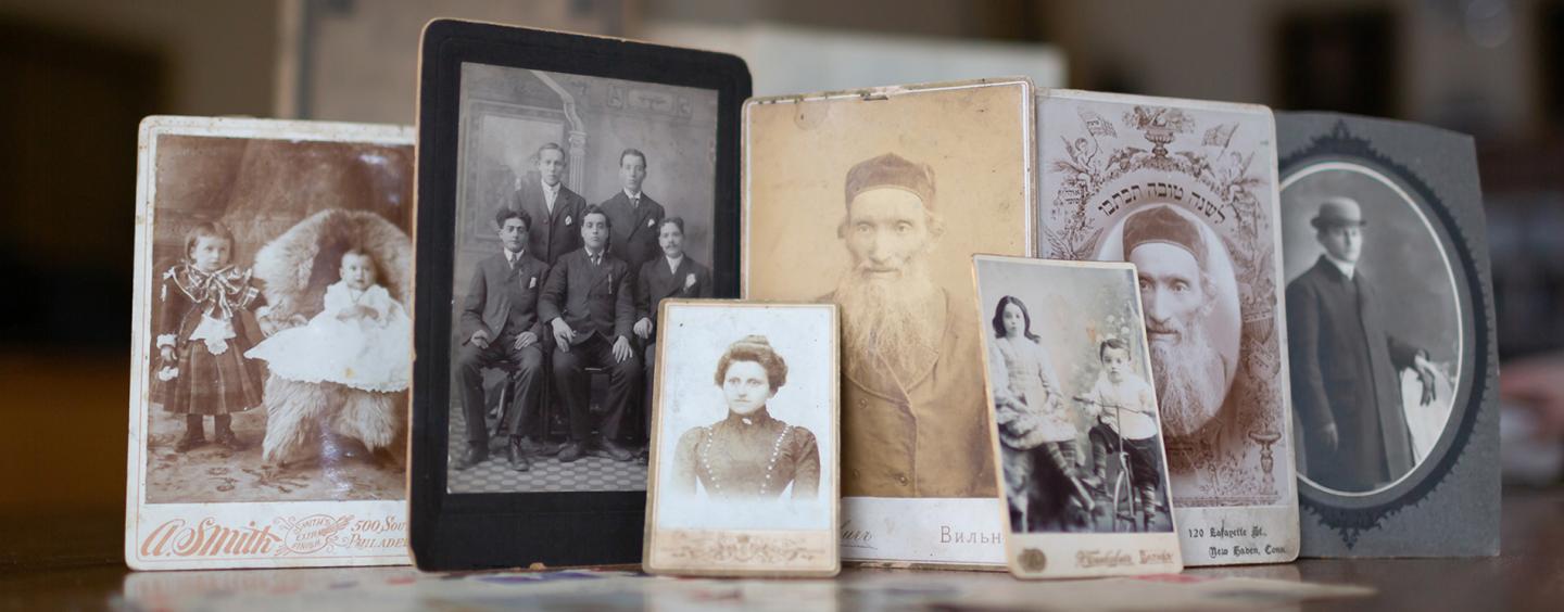 Various printed photographs displayed on table