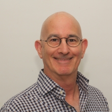 Image of scholar Benjy Maor wearing glasses and a checkered button up shirt.