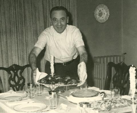 Jack Fox serving dinner, circa 1950s, Jewish Neighborhood Voices collection in the JHC archive.